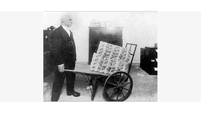 Man with a Wheelbarrow of Money Shows Hyperinflation in Germany